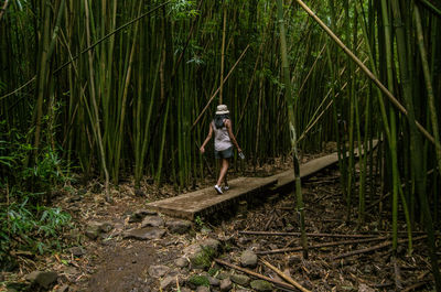 Woman standing in forest