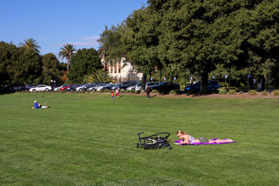 Group of people relaxing on grassland