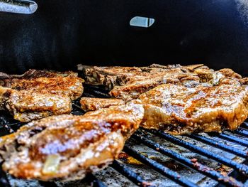High angle view of meat on barbecue grill