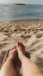 Low section of person relaxing on beach