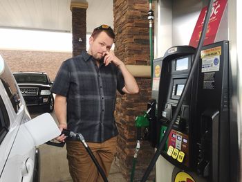 Portrait of mature woman working at fuel station