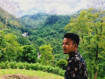 Portrait of young man looking at forest