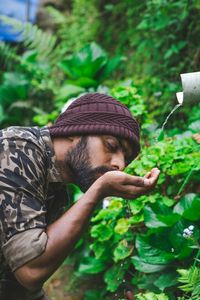 Close-up of man drinking in forest 