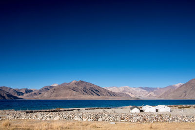 Scenic view of land against clear blue sky