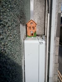 Close-up of telephone pole against building