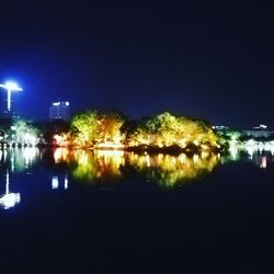 Scenic view of lake against sky at night