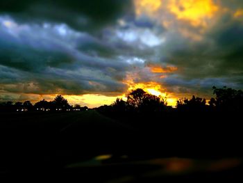 Silhouette trees against sky during sunset