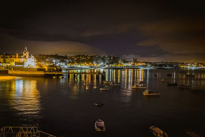 Illuminated city at waterfront