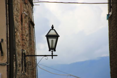 Low angle view of street light against cloudy sky