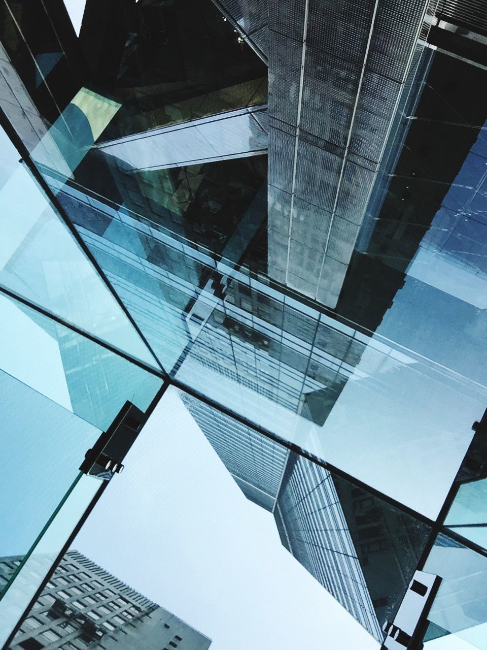 architecture, low angle view, building exterior, built structure, modern, office building, city, skyscraper, tall - high, building, tower, sky, glass - material, reflection, directly below, day, development, outdoors, no people, tall