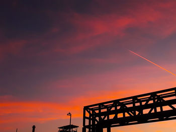 Low angle view of silhouette bridge against sky during sunset