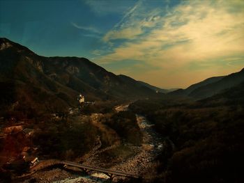 Scenic view of mountains against cloudy sky