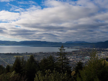 View of cityscape against cloudy sky