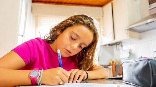 Girl writing on a piece of paper