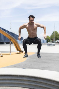 Male athlete exercising on road