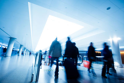 People walking in illuminated building