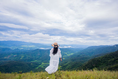 Man standing on mountain against sky