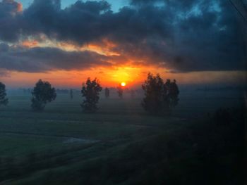 Scenic view of field against sky during sunset