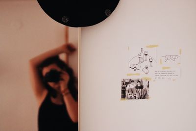 Shadow of person holding text on wall