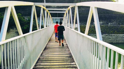 Man walking on footbridge