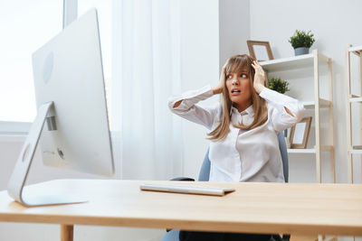 Portrait of young businesswoman working at desk in office