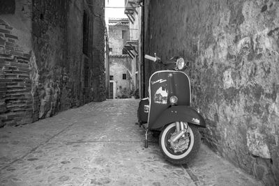 Motorcycle on street amidst buildings in city