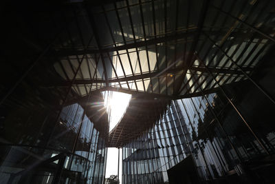 Low angle view of sunlight streaming through ceiling in building