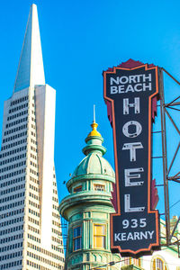 Low angle view of text on building against clear sky