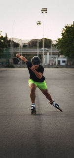 Full length of man inline skating on road against sky