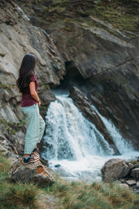 Full length of woman standing on rock formation