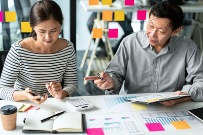 Side view of business colleagues working at office