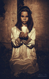 Portrait of a young woman sitting outdoors