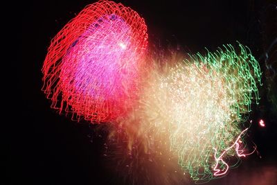 Low angle view of firework display at night