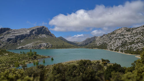 Scenic view of lake and mountains against sky