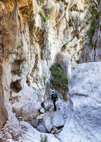 Full length of person on rocks against mountain