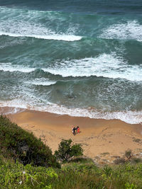 Two surfers in the beach of suances ready to start action