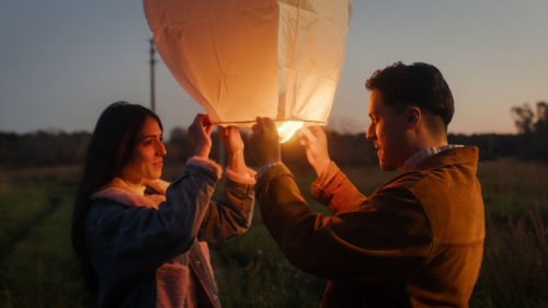 Boy and girl couple are preparing the chinese lantern