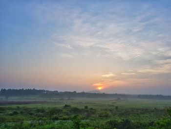 Scenic view of field against sky during sunset