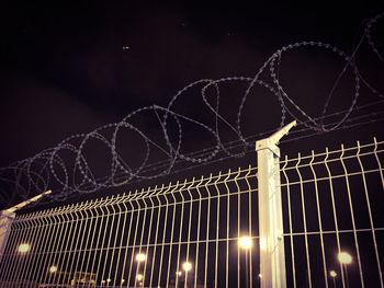Low angle view of illuminated lights at night