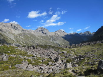 Scenic view of mountains against blue sky