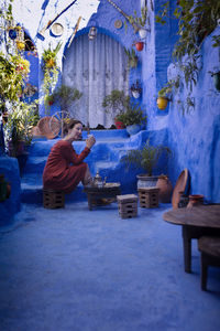 Woman with orange dress in chefchaouen vi