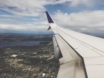 Cropped airplane flying over landscape