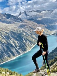 Man with arms outstretched against mountains