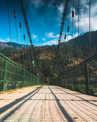 Low angle view of footbridge against sky