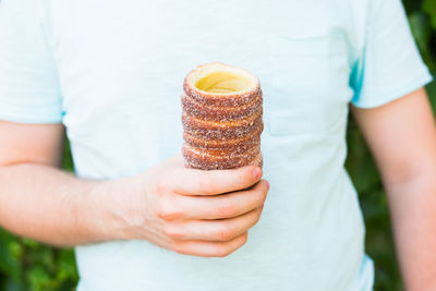 Midsection of woman holding ice cream