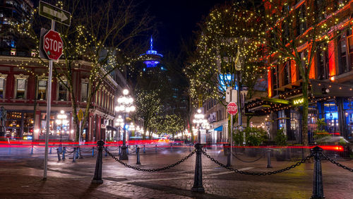 Illuminated street in city at night during christmas