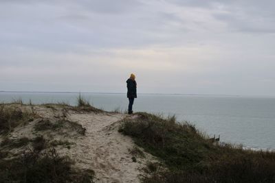 Man looking at sea against sky