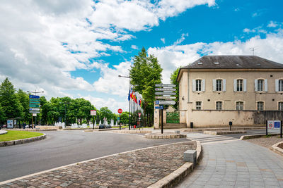 Street amidst buildings in city against sky