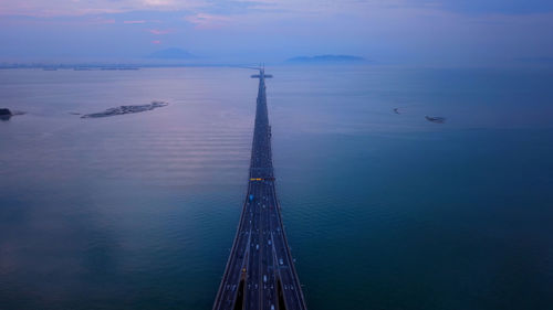 High angle view of bridge over sea against sky during sunset