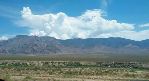 Scenic view of landscape against blue sky